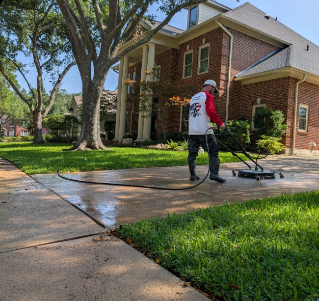 Pressure Washing America Technician performing expert driveway cleaning in Houston