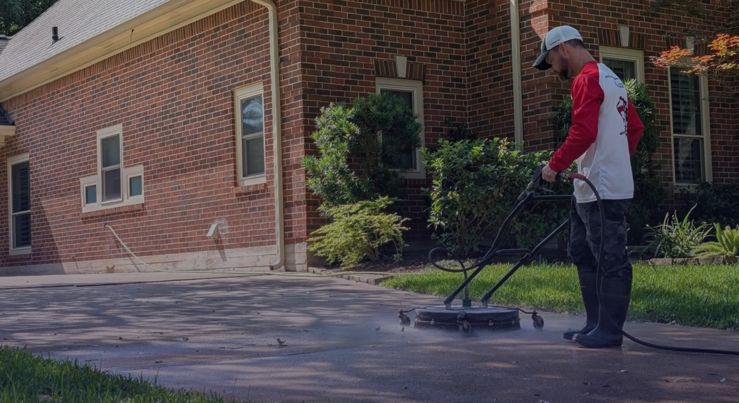 Pressure Washing Services Houston, TX – Pressure Washing America Expert cleaning driveway with power washer at brick home
